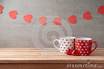 Valentine`s day background with coffee cups, heart shape chocolate and garland Stock Photo