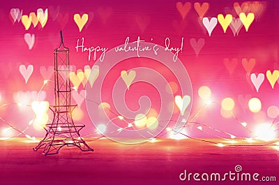 Valentine's day background. Eiffel tower over wooden table and purple background. Stock Photo