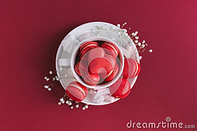 Valentine`s day background with pink french heart-shaped macarons and marshmallows. Flat lay Stock Photo