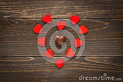 Valentine`s day background. Red hearts placed in heart shape on the wooden desk Stock Photo