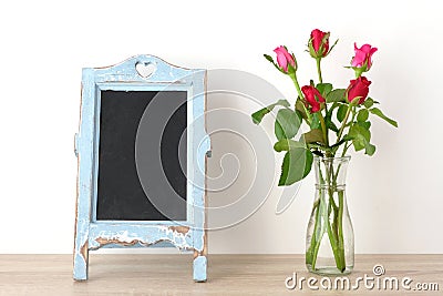 Valentine`s day background, Red roses and blank vintage chalkboa Stock Photo