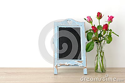 Valentine`s day background, Red roses and blank vintage chalkboa Stock Photo