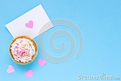 Valentine`s Day background. Valentine`s day card and cupcake with copy space on the blue background Stock Photo