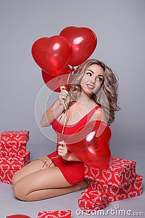 Valentine's Day. Beautiful happy woman with red heart balloons o Stock Photo