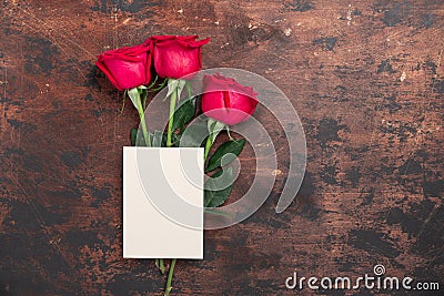 Valentine`s day blank card with red rose flowers on vintage wooden background. Valentines day mockup Stock Photo