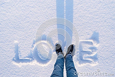 Valentine`s Day card with the word love in the snow Stock Photo