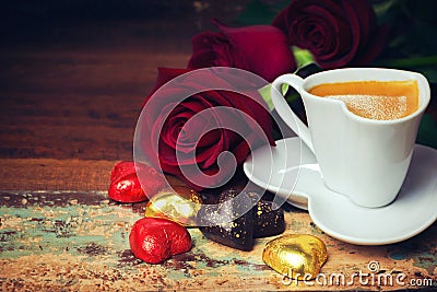 Valentine's day celebration with heart chocolate, coffee cup and roses on wooden background Stock Photo