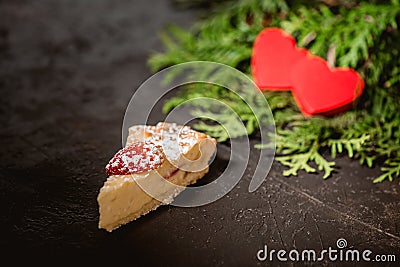 Cheesecake on Valentine`s Day with strawberry, kiwi hearts on fir and wood background Stock Photo