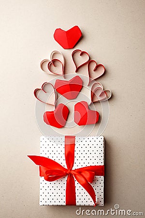 Valentine`s Day. Composition made of gift, origami hearts and ribbon on gray background. Valentines day background. Flat lay, top Stock Photo