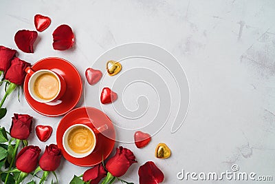 Valentine`s day concept with coffee cups, heart shape chocolate and rose flowers on bright background. Top view. Flat lay Stock Photo