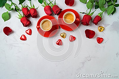 Valentine`s day concept with coffee cups, heart shape chocolate and rose flowers on bright background. Top view. Flat lay Stock Photo