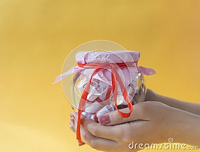 Valentine`s day concept. Woman holding or giving as a gift to her lover Jar of papers with sweet desires, wishes or dreams Stock Photo