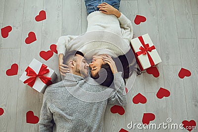 Valentine`s day. Couple gives heart to the Valentine`s Day in the room. Top view Stock Photo