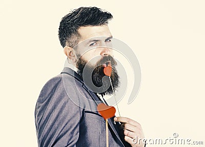 Valentine`s Day. Flirtation concept. Hipster with red hearts flirts. Dating and flirtation Stock Photo