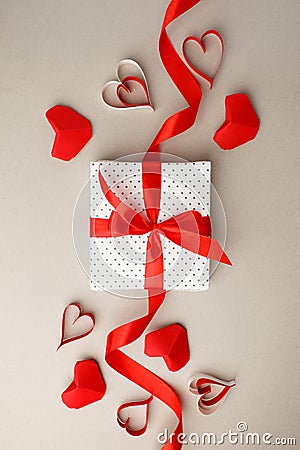 Valentine`s Day. Frame made of gift, origami hearts and ribbon on gray background. Valentines day background. Flat lay, top view, Stock Photo