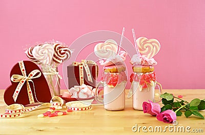 Valentine`s Day freak shakes with heart shaped lollipops and donuts. Stock Photo