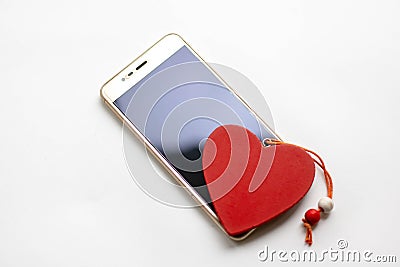 Valentine`s day greeting card with heart gift boxes and smartphone on white background. Top view with space for your greetings or Stock Photo