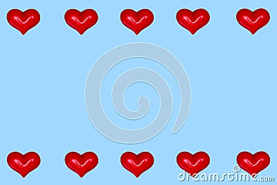 Valentine`s Day greeting card. Red hearts in a row on a blue background. A frame of hearts. Copy space Stock Photo