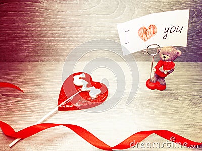 Valentine`s day heart teddy bear and sweet lollipop Stock Photo
