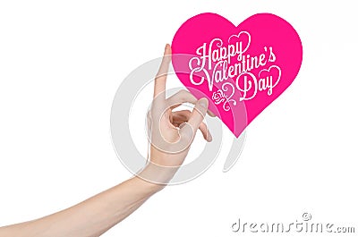 Valentine's Day and love theme: hand holds a greeting card in the form of a pink heart with the words Happy Valentine's day Stock Photo