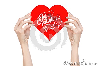 Valentine's Day and love theme: hand holds a greeting card in the form of a red heart with the words Happy Valentine's day Stock Photo