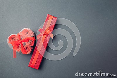 Valentine`s day presents. Red gift box and heart shaped box with soap roses Stock Photo