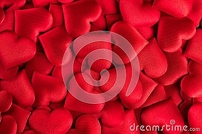 Valentine`s Day. Red heart shape backdrop. Abstract holiday Valentine background with red satin hearts. Love Stock Photo