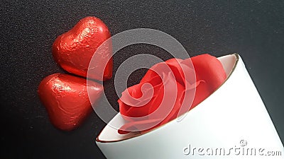 Valentine`s Day two red hearts, red rose in porcelain vase. Black bacground. Stock Photo