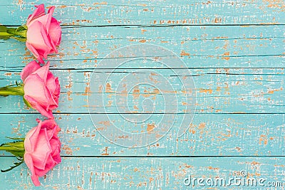 Valentine`s Day or Wedding card with romantic pink roses on soft blue wooden background Stock Photo