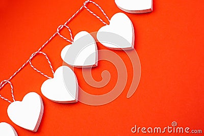Valentine`s Day. White wooden hearts on a red background. Blank for the designer. Valentines day concept. Greeting card Stock Photo