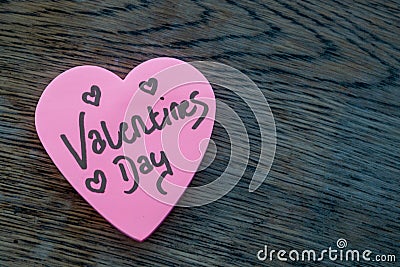 Valentineâ€™s Day wrote text on pink love heart with drawn hearts. On rustic wooden background. Love Valentines concept Stock Photo