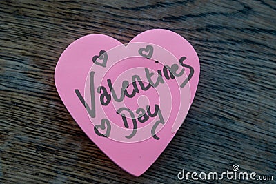 Valentineâ€™s Day wrote text on pink love heart with drawn hearts. On rustic wooden background. Love Valentines concept Stock Photo