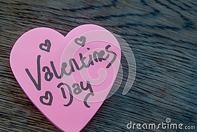 Valentineâ€™s Day wrote text on pink love heart with drawn hearts. On rustic wooden background. Love Valentines concept Stock Photo