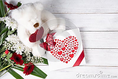 Valentine's day gift, teddy bear with a heart, a box of pralines and a bouquet Stock Photo