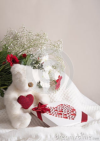 Valentine& x27;s day gift, teddy bear with a heart, a box of pralines and a bouquet Stock Photo
