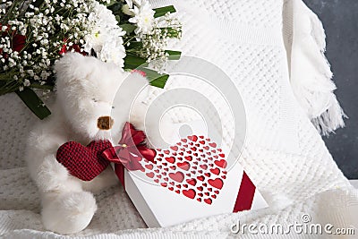 Valentine& x27;s day gift, teddy bear with a heart, a box of pralines and a bouquet Stock Photo