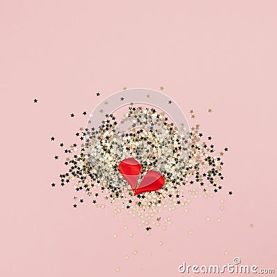 Valentines abstract Top view of golden stars confetti red heart in two pieces with copy space millennial pink color paper Stock Photo