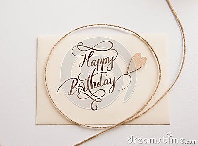 Valentines card with wooden heart and text Happy Birthday. Calligraphy lettering Stock Photo