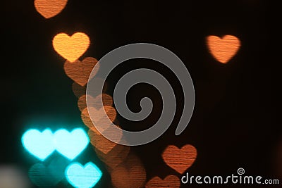 Valentines Colorful heart-shaped on black background lighting bokeh for decoration at night backdrop wallpaper blurred valentine Stock Photo