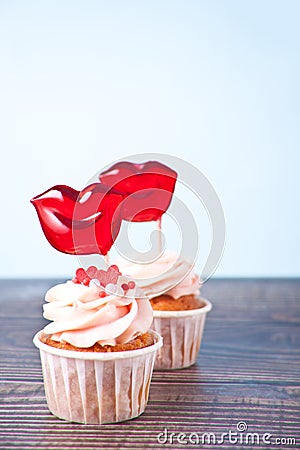 Valentines cupcakes cream cheese frosting decorated with lips shaped hard candy lollipops Stock Photo