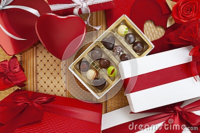 Valentines day background composition of gift boxes chocolates and red heart metal shaped boxes with bows and ribbons top view Stock Photo