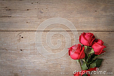 Valentines day background with red rose and ribbon on wooden. Stock Photo