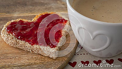 Valentines Day Breakfast, heart shaped toast with strawberry jam and coffee Stock Photo