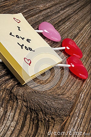 Valentines day candy,sticky-note pad on barnwood Stock Photo