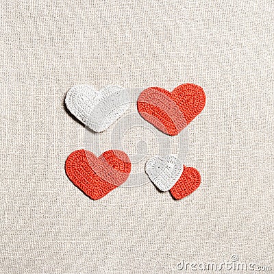 Valentines day concept, knit hearts valentine as creative square pattern, handmade colored crochet heart on cloth table Stock Photo