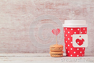 Valentines day concept with paper coffee cup and macarons. Romantic coffee shop Stock Photo