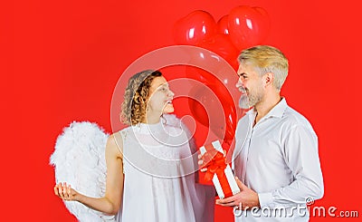 Valentines Day Couple. Cupid angel with presents and balloons. Lovely Couple in valentine day. Stock Photo