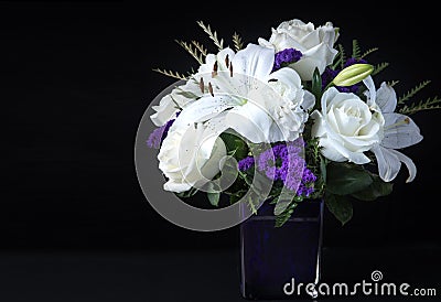 Valentines Day Funeral Bouquet purple White flowers, Sympathy and Condolence Concept on blackbackground Stock Photo