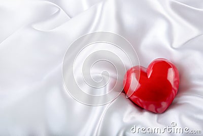 Valentines day. Hand made valentine heart. Wedding day. Red valentines hearts on white satin. Text: I love you Stock Photo