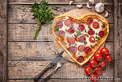 Valentines day heart shaped pizza with pepperoni Stock Photo